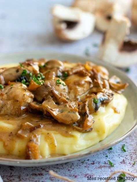 Poulet au champignon servi avec purée au fromage, plat savoureux et réconfortant